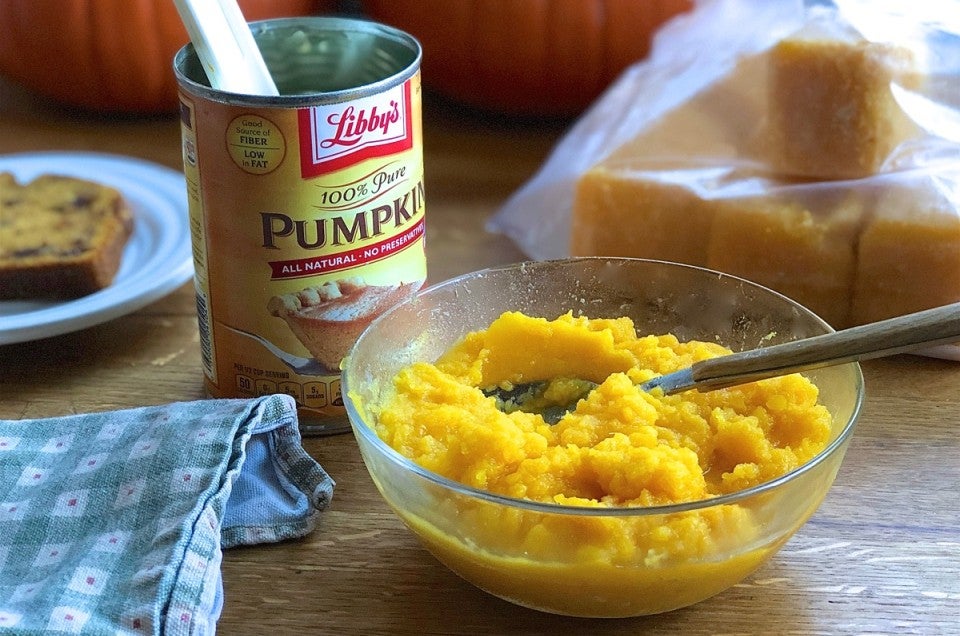 Opened can of pumpkin, bowl of homemade pumpkin purée