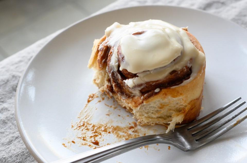 Sourdough cinnamon bun topped with icing.