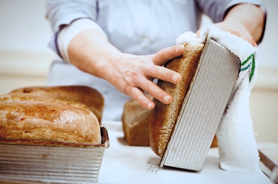 Loaves of hot bread in pans.