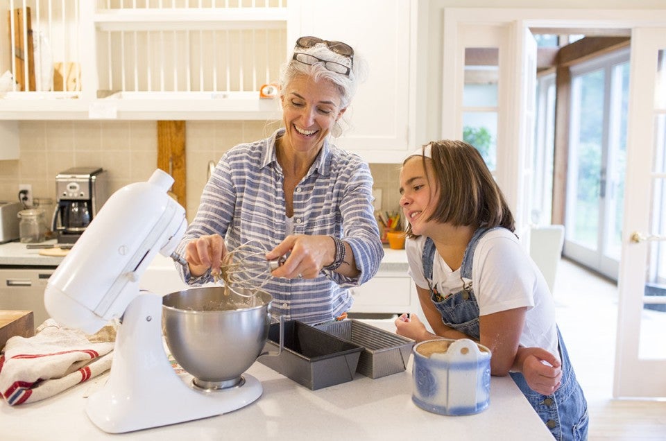 Woman and young girl baking together