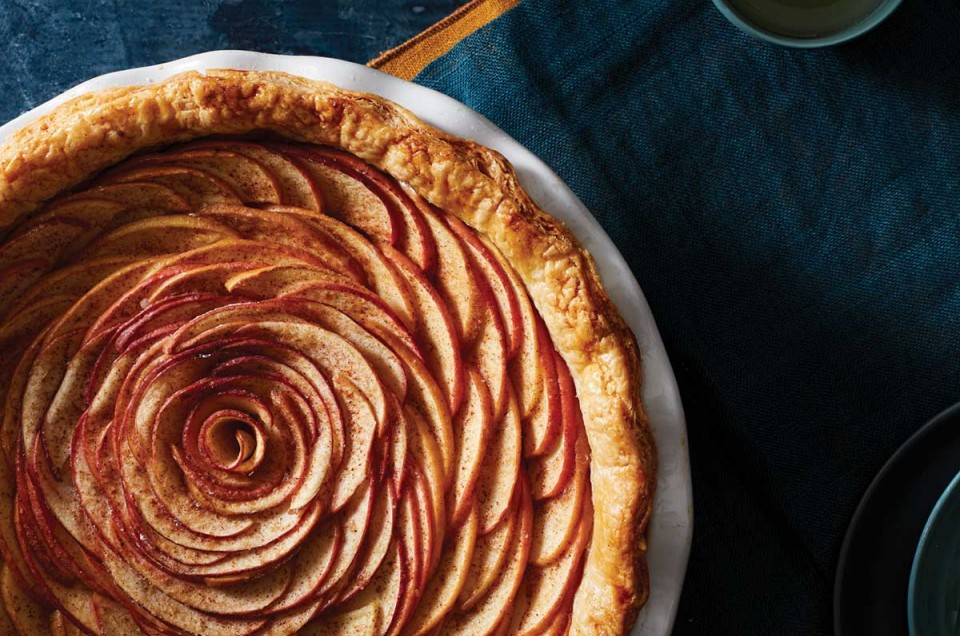 An apple pie with the apple slices arranged in a rose-like pattern