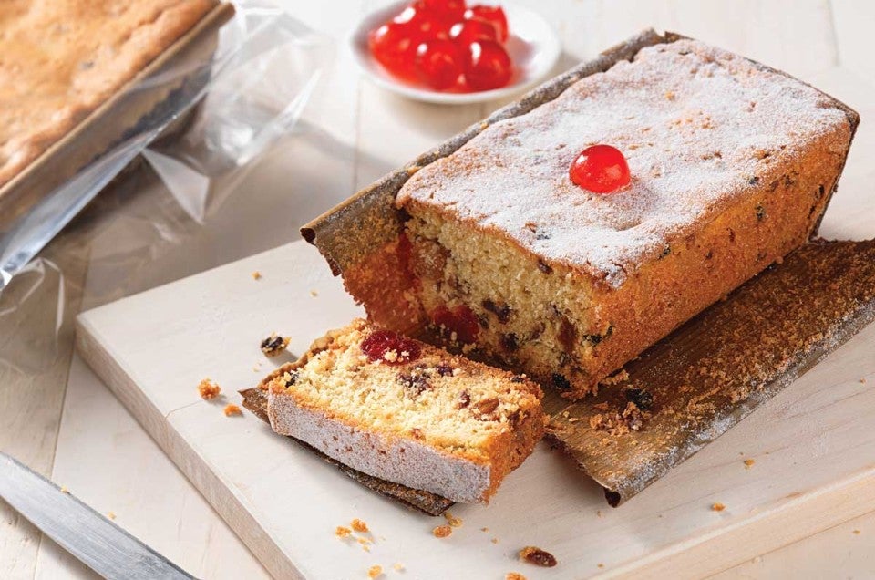 Sliced fruitcake topped with candied cherries