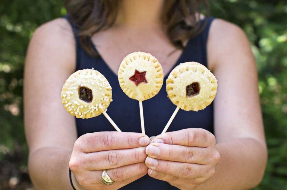 Woman holding up three pie pops