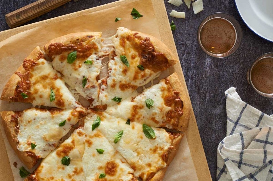 Cheese pizza on cutting board