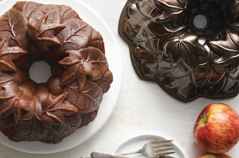 Bundt cake next to dark Bundt pan