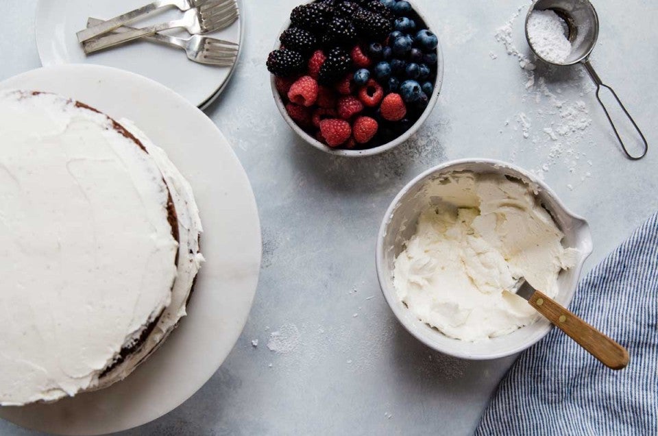 Cake next to bowl of frosting