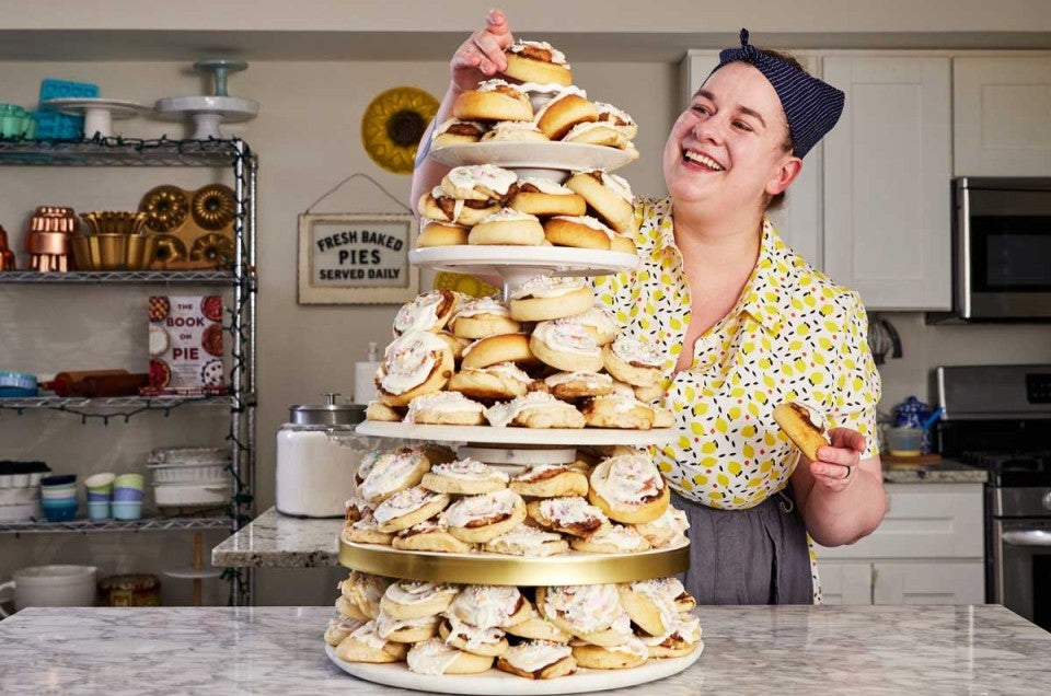 Erin placing a roll on her cinnamon roll tower