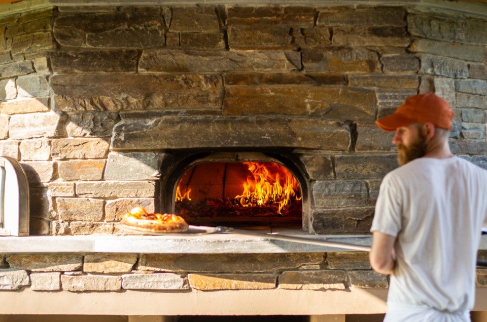 Baker using a wood-fired oven