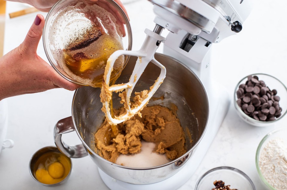 Pouring brown butter into cookie dough