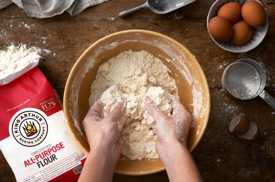 Hands in bowl of flour