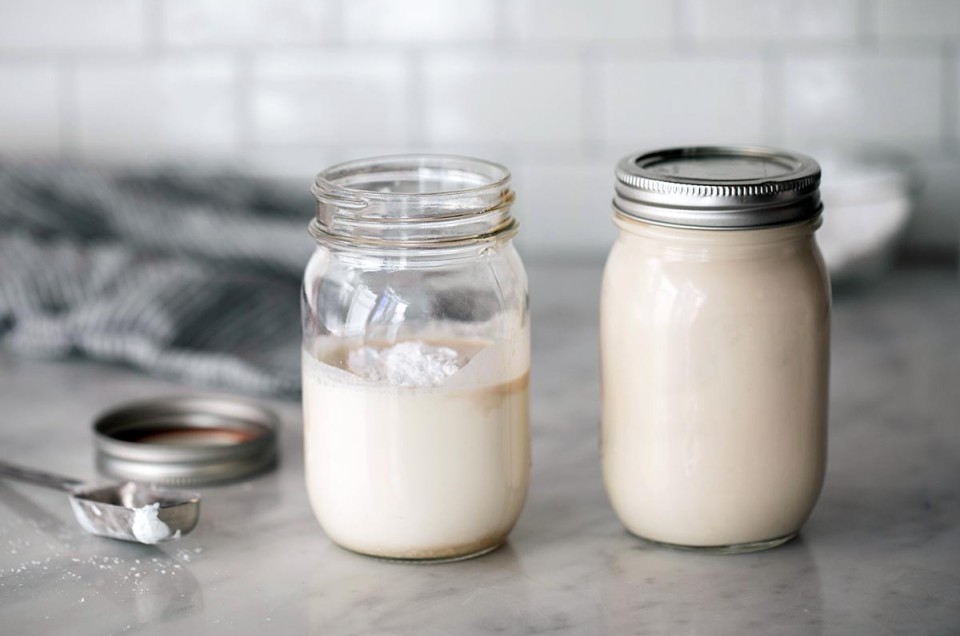 Two mason jars, one filled with cream ready to be shaken and the other filled with whipped cream
