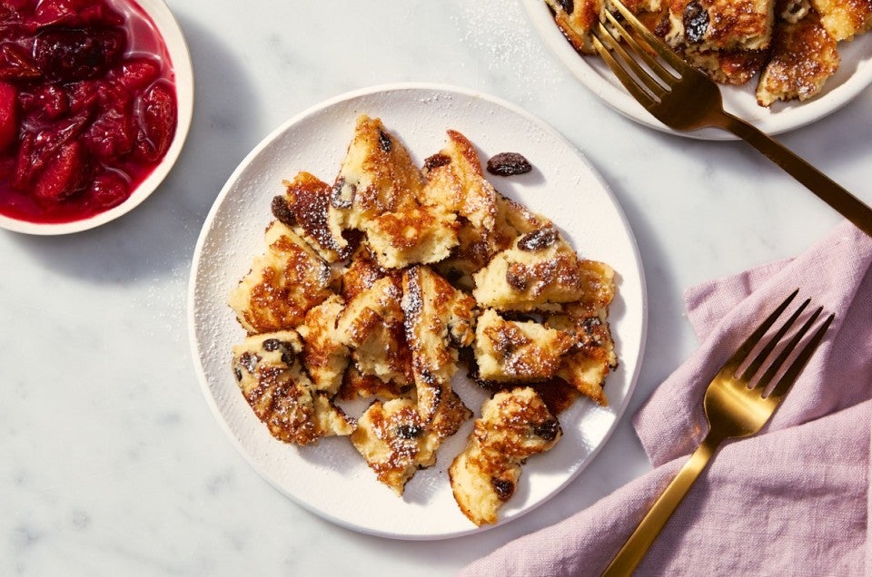 Kaiserschmarrn on a serving plate, fruit compote on the side.