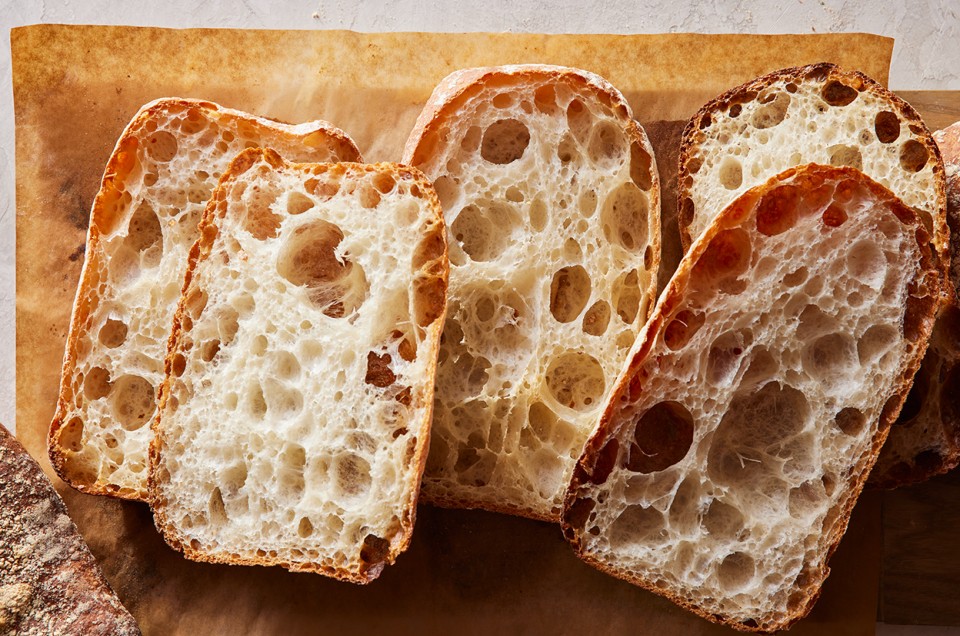 Loaves of Pan de Cristal cut in half showing their very open crumb structure - select to zoom