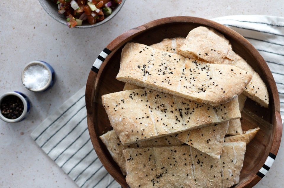 A bowl of Afghan naan topped with black and white sesame seeds - select to zoom