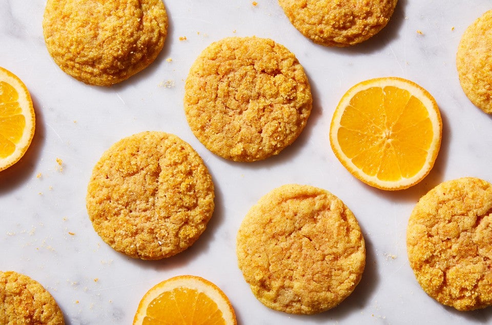 Orange Olive Oil Sugar Cookies next to slices of oranges - select to zoom