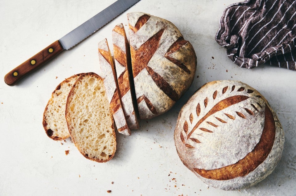 One loaf of sliced sourdough and one whole loaf of sourdough