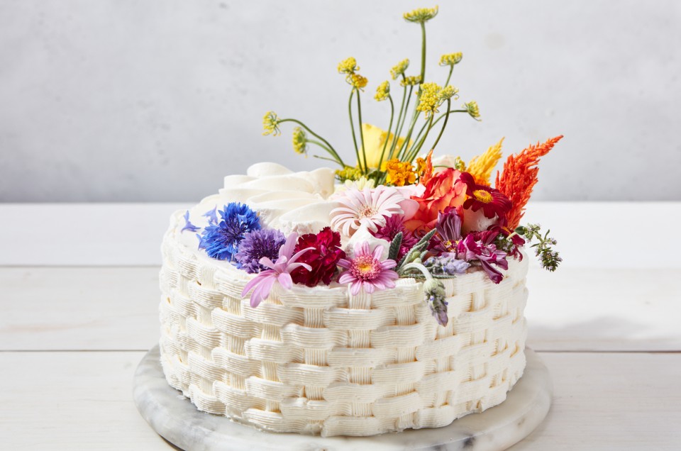 Basket weave cake decorated with a rainbow of flowers