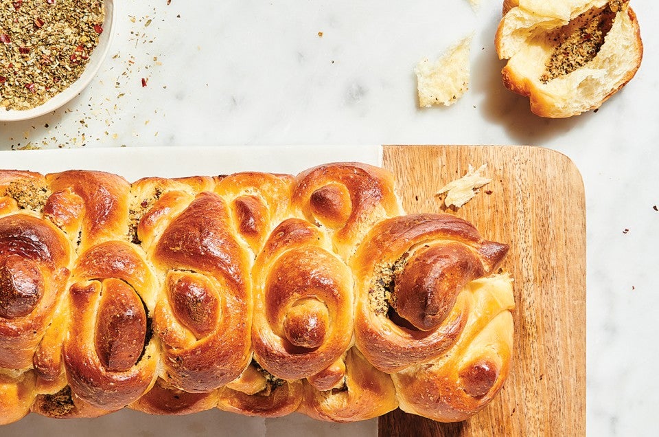 Handkerchief Butterflake Herb Rolls on cutting board on counter - select to zoom