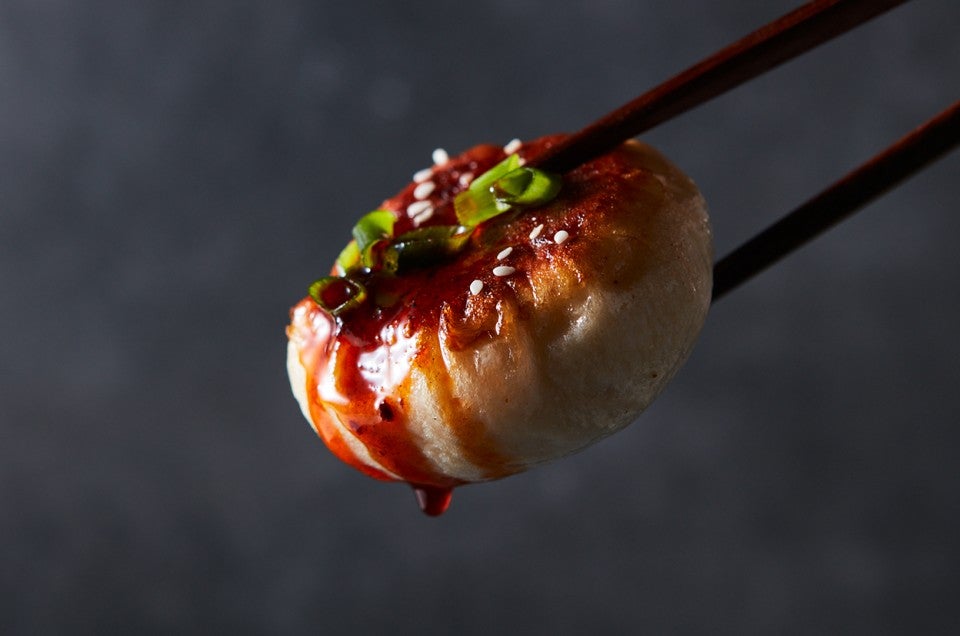 Mushroom and Cabbage Pan-Fried Bun in chopsticks - select to zoom