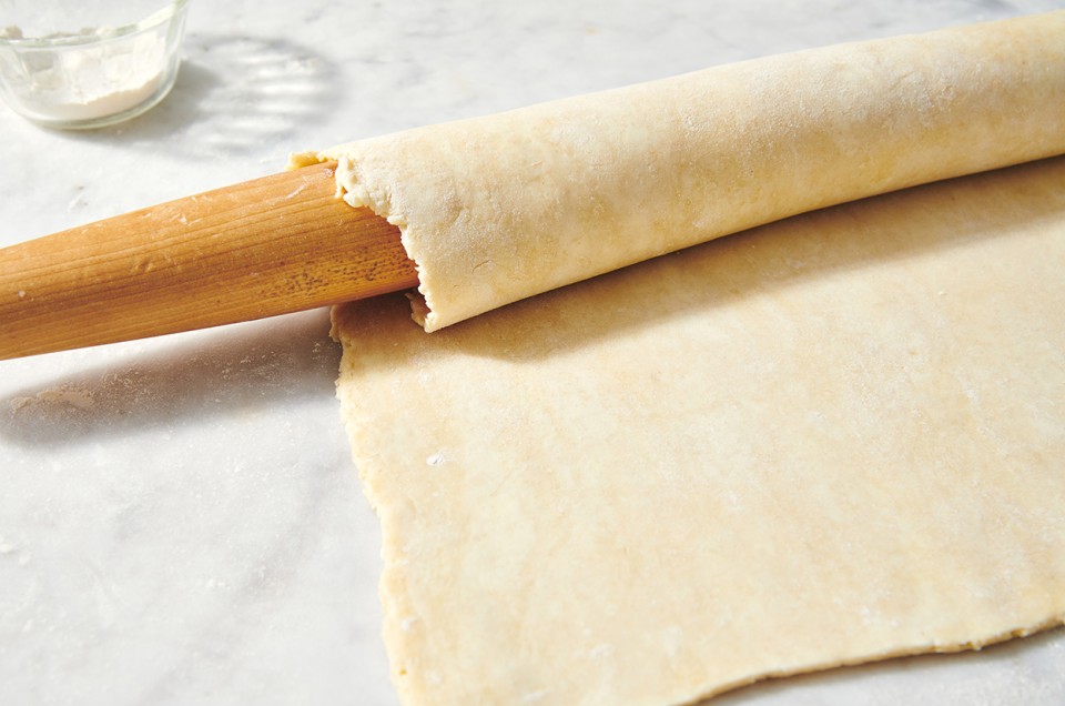 All-Purpose Flaky Pastry Dough rolled around a rolling pin - select to zoom