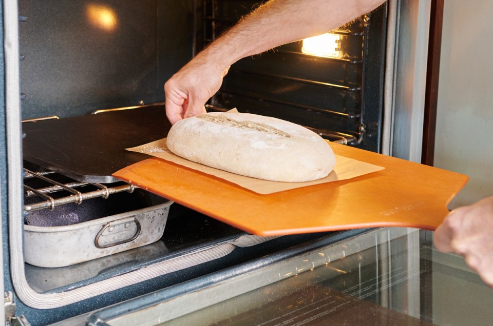 Sliding bread into oven with towels