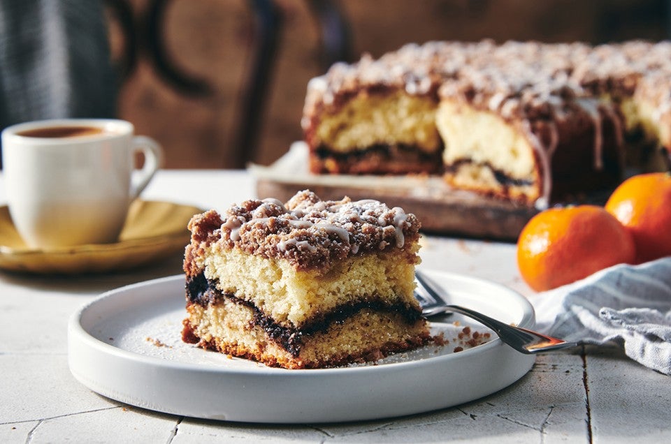 Slice of Cinnamon-Crisp Coffee Cake on a plate with coffee - select to zoom