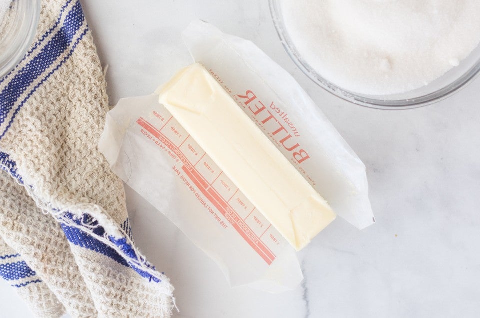 Stick of unwrapped butter on counter