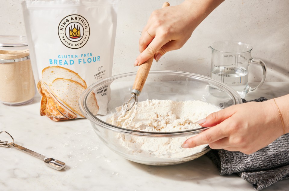 Baker mixing bread dough with gluten-free bread flour