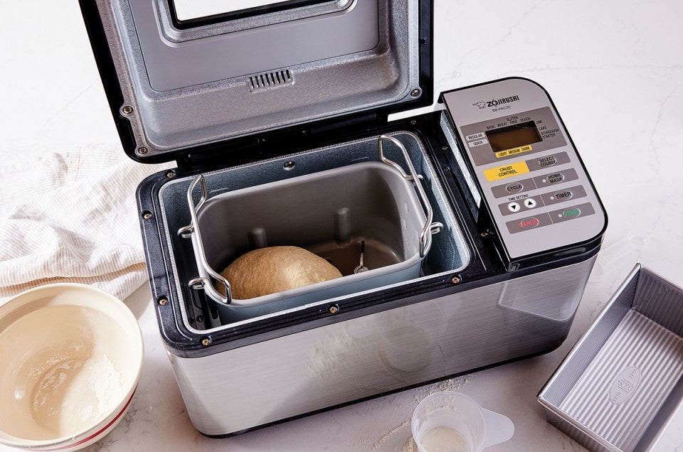 Open bread machine with dough inside