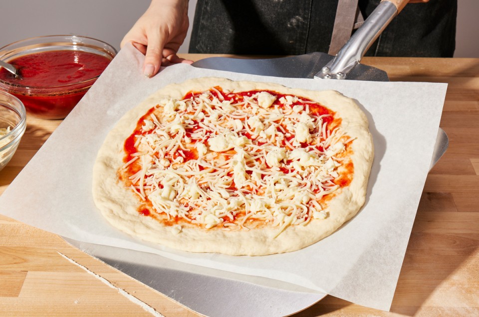 Unbaked pizza on a peel