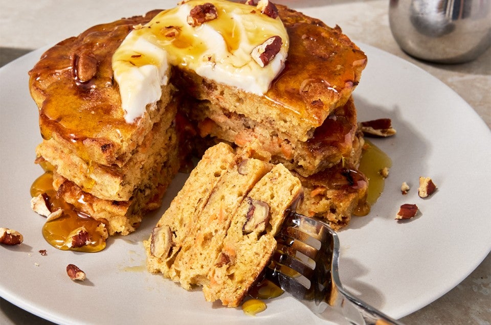 Carrot Cake Pancakes on a plate with a slice taken out - select to zoom