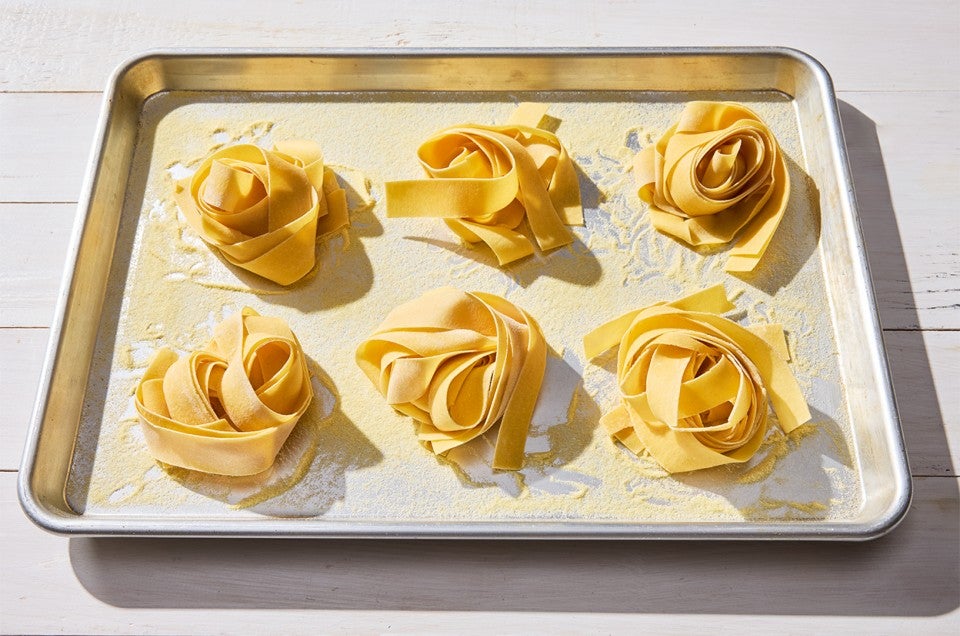 Fresh Pasta nests on a baking sheet - select to zoom