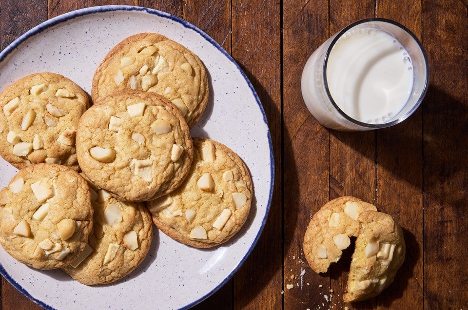 White Chocolate Macadamia Nut Cookies on a plate with a glass of milk - select to zoom
