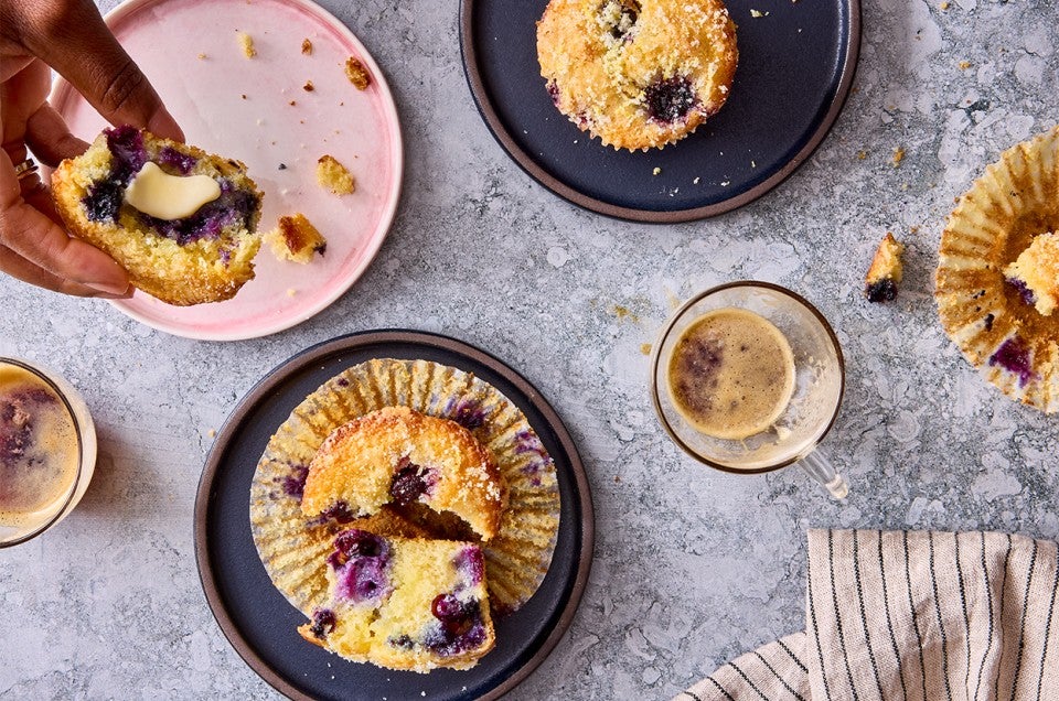 Lemon Blueberry Muffins on plates with coffee - select to zoom