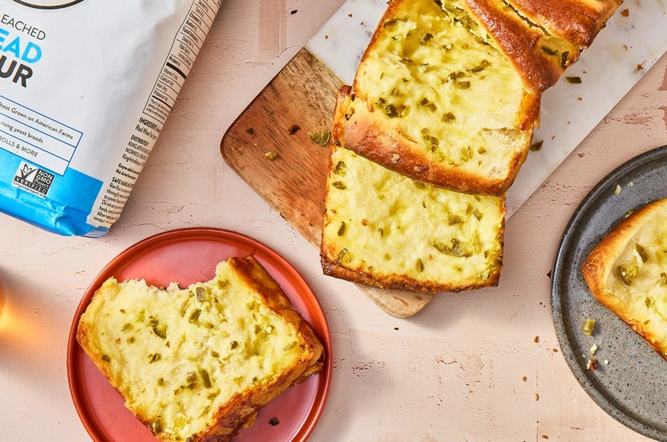 Jalapeño-Cheddar Pull-Apart Bread on a cutting board and served on a plate - select to zoom