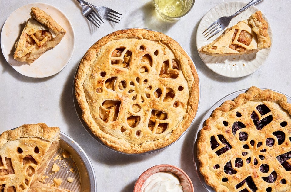 Three Apple Pie with Make-Ahead Filling in pie pans and two slices on plates - select to zoom