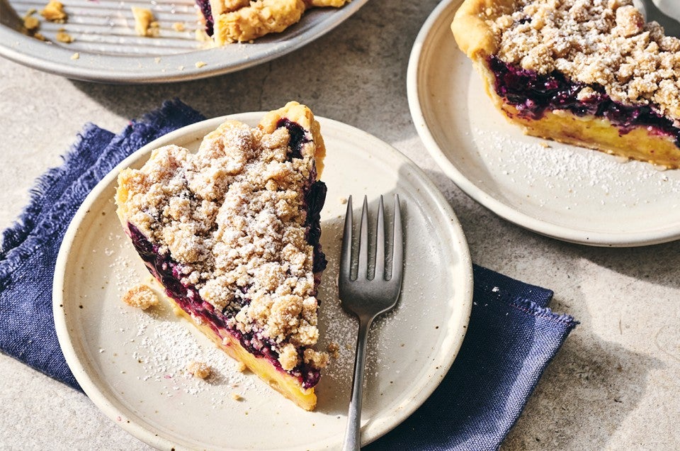 A slice of Lemon-Blueberry Streusel Pie on a plate - select to zoom