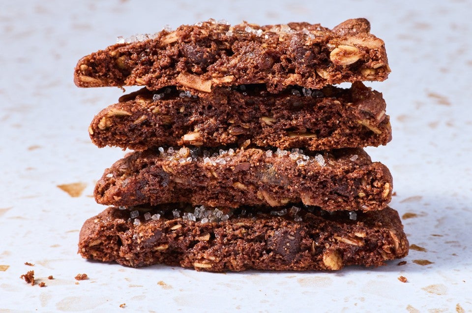 Vegan and gluten-free chocolate cookies shown sliced and stacked from the side. - select to zoom