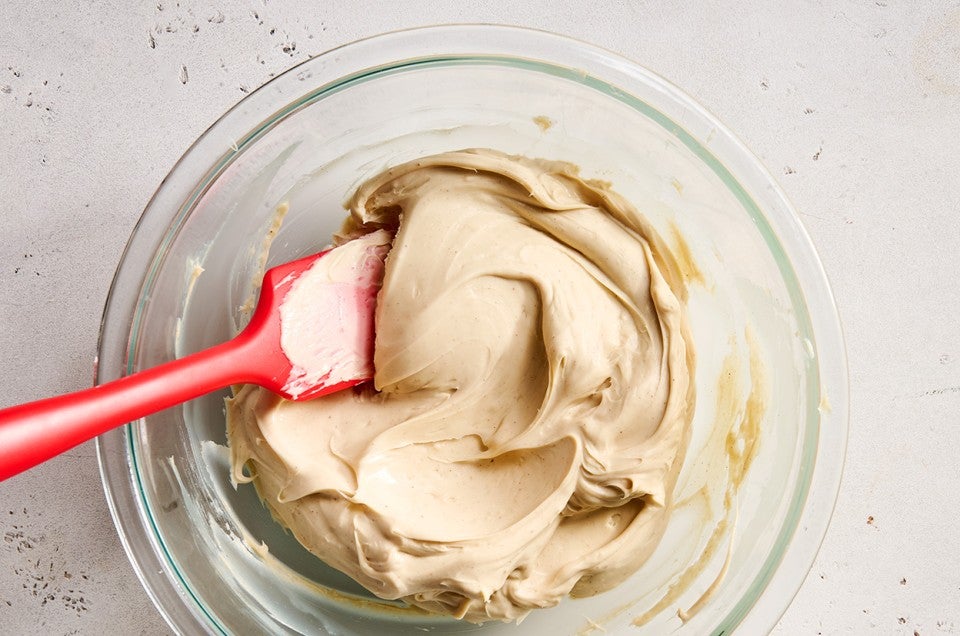 Cookie Butter Whipped Ganache being made in a clear class bowl. - select to zoom