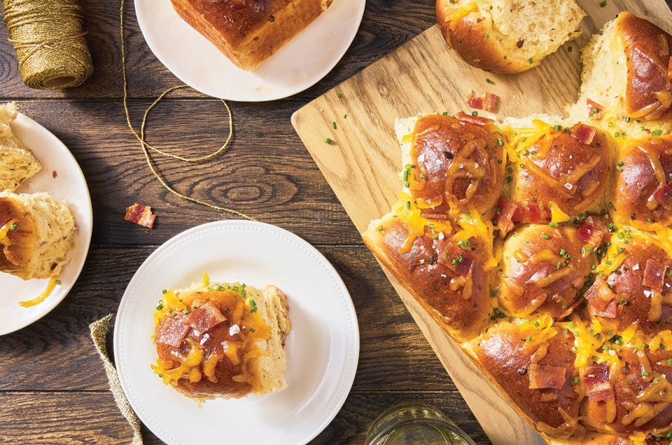 Loaded Baked Potato Dinner Rolls on a cutting board - select to zoom