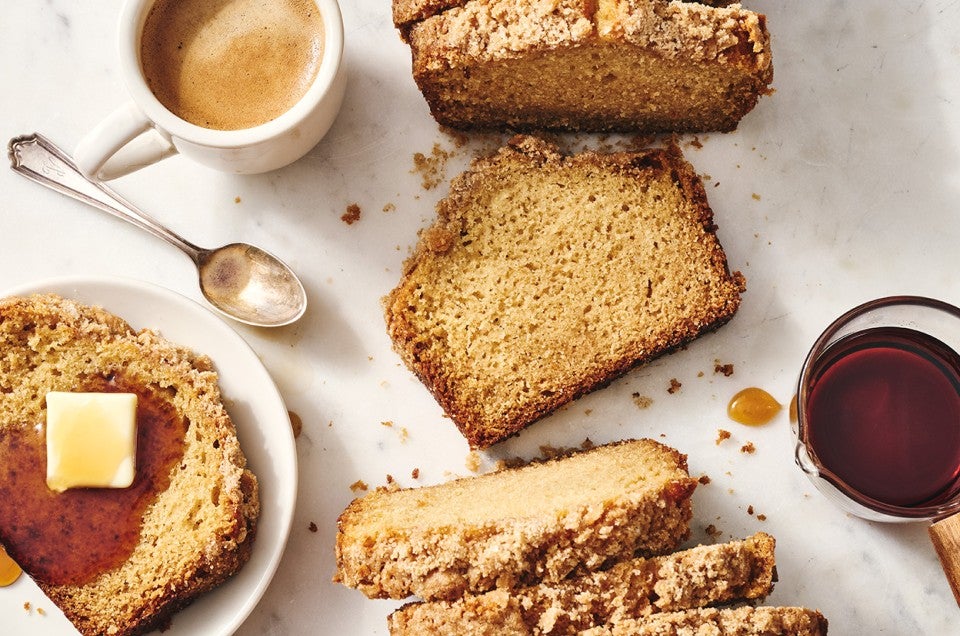 Several slices of Pancake Bread arranged on a table seen from above with maple syrup and butter. - select to zoom