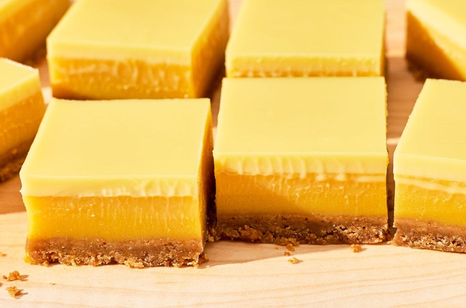 Passionfruit Bars - angled side view - layers of yellow passionfruit curd, crust, and cream. - select to zoom