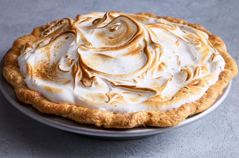 Swirled, baked, and lightly browned Swiss meringue atop a freshly baked pie. - select to zoom