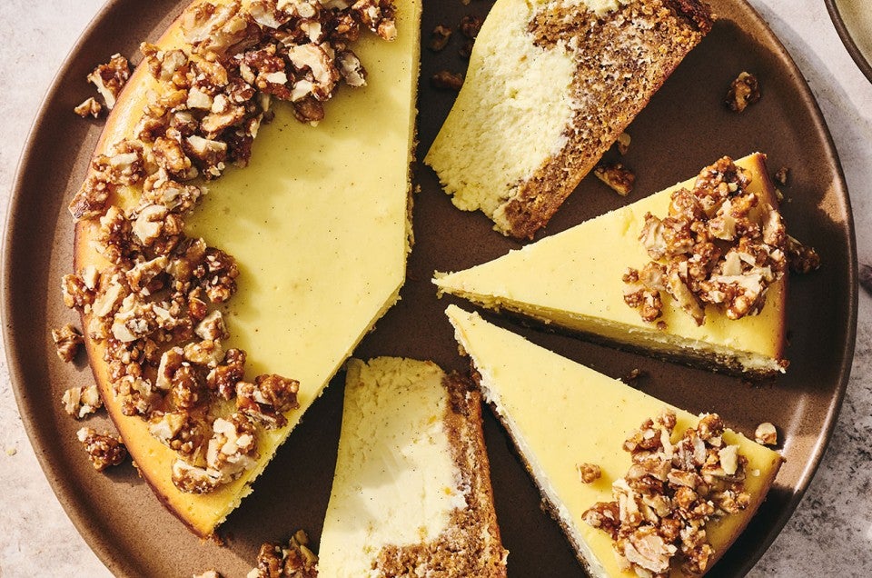 Carrot Cake Cheesecake with golden creamy cheesecake and edged with walnuts. - select to zoom