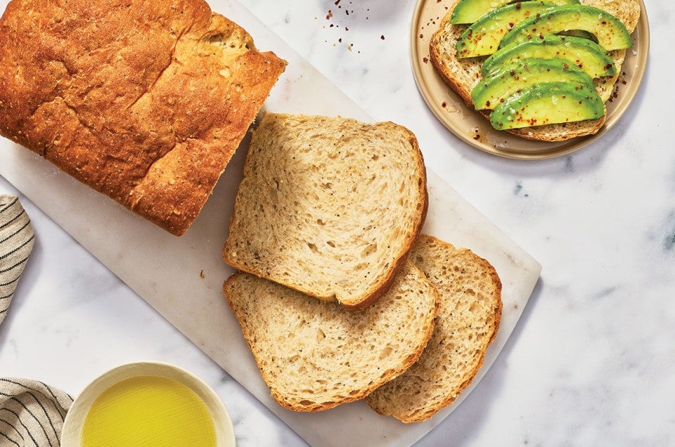 Clay's Multigrain Sourdough sliced and laid on a countertop. - select to zoom