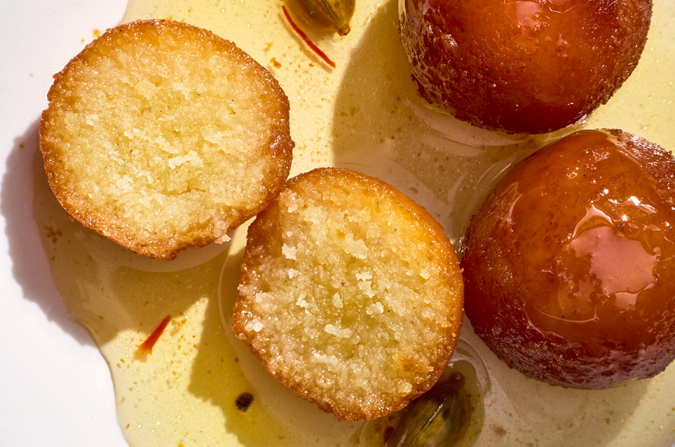 Gulab Jamun sliced and showing a cross-section of the treat. - select to zoom