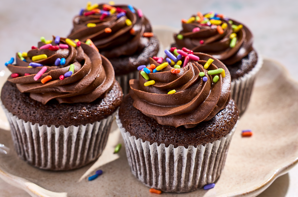 4 Small-Batch Chocolate Cupcakes on a plate with chocolate frosting and sprinkles. - select to zoom