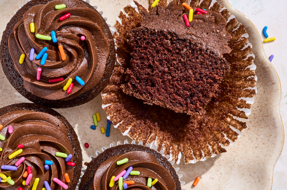 Small-Batch Chocolate Cupcakes seen from above with one sliced in half. - select to zoom