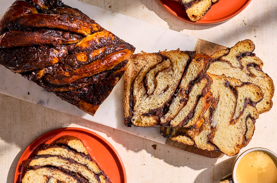 Chocolate Sourdough Babka sliced and arranged with other elements on a counter and seen from above. - select to zoom