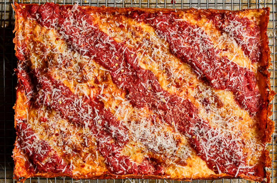 Detroit Pizza seen from above with classic cheese then sauce preparation. - select to zoom